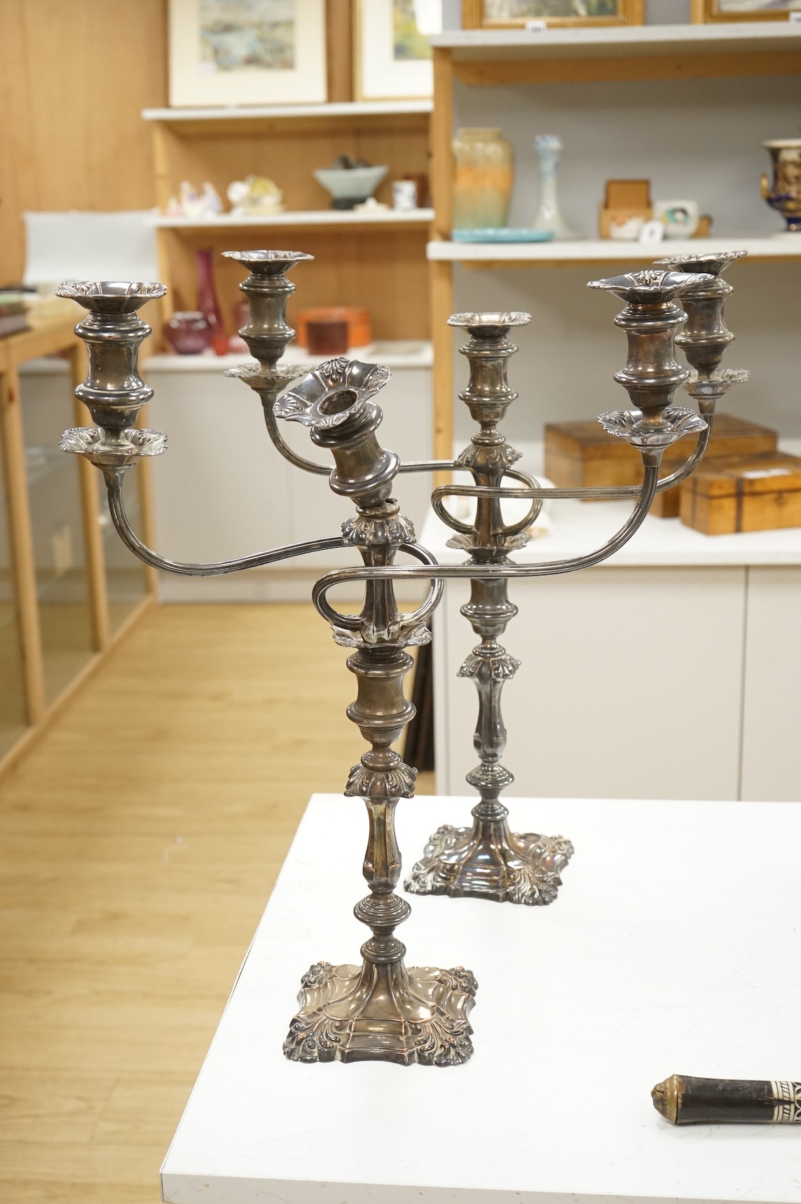 A pair of silver plated two branch three light candelabra, 53cm high